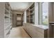 Organized walk-in closet offers custom shelving, drawers, and a window for natural light at 4414 N 29Th St, Phoenix, AZ 85016