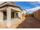 Backyard featuring a covered patio, dirt landscaping, and block wall at 11624 W Beck Dr, Youngtown, AZ 85363