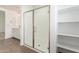 Bathroom shower featuring glass doors, white interior and storage shelves at 11624 W Beck Dr, Youngtown, AZ 85363