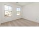 Bedroom featuring neutral carpet, a window with views and bright white walls at 11624 W Beck Dr, Youngtown, AZ 85363