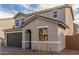 Exterior view of a two-story home with a two-car garage at 11624 W Beck Dr, Youngtown, AZ 85363