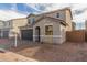 Charming two-story home featuring a gray exterior, arched entry, dark garage door, and low-maintenance landscaping at 11624 W Beck Dr, Youngtown, AZ 85363