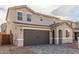 Exterior view of a two-story home with a two-car garage at 11624 W Beck Dr, Youngtown, AZ 85363