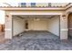 Spacious two-car garage with clean concrete floor and ample lighting at 11624 W Beck Dr, Youngtown, AZ 85363