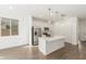 Bright kitchen featuring an island, stainless steel appliances, and white cabinetry at 11624 W Beck Dr, Youngtown, AZ 85363