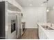 Close-up of a kitchen with stainless steel appliances, island, and white cabinets at 11624 W Beck Dr, Youngtown, AZ 85363