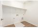 A clean laundry room with a shelf, and tile flooring at 11624 W Beck Dr, Youngtown, AZ 85363