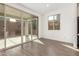 Bright living room area with tile floors, sliding glass doors, and a window at 11624 W Beck Dr, Youngtown, AZ 85363