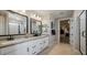 Elegant bathroom with double vanity, large mirror, and walk-in shower at 12712 W Corona Ave, Avondale, AZ 85392