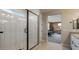 Modern bathroom with a large walk-in shower and view to bedroom at 12712 W Corona Ave, Avondale, AZ 85392