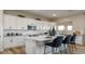 Modern kitchen with white cabinets, quartz countertops and breakfast bar at 12712 W Corona Ave, Avondale, AZ 85392