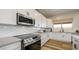 Modern kitchen with white cabinets, stainless steel appliances and hexagon tile backsplash at 12712 W Corona Ave, Avondale, AZ 85392