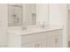 Bathroom features a double sink vanity with white cabinets and hardware at 16001 W Cottontail Ln, Surprise, AZ 85387