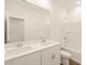 Bathroom features a double sink vanity and a shower-tub combo with tiled walls, providing a spa-like feel at 16001 W Cottontail Ln, Surprise, AZ 85387