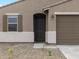 Close up exterior shot of a single Gathering home showcasing the front door at 16001 W Cottontail Ln, Surprise, AZ 85387