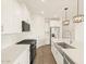 Bright, white modern kitchen with stainless steel appliances and wood-look flooring at 16001 W Cottontail Ln, Surprise, AZ 85387