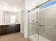 Well-lit bathroom featuring double sinks and large glass enclosed walk in shower at 16005 W Cottontail Ln, Surprise, AZ 85387