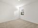 Bright bedroom features neutral carpet and natural light from the window at 16005 W Cottontail Ln, Surprise, AZ 85387