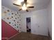 Bedroom with gold and pink accent wall, ceiling fan, and closet at 812 W Saint Anne Ave, Phoenix, AZ 85041