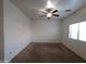 Spacious bedroom with carpeted flooring and a ceiling fan at 812 W Saint Anne Ave, Phoenix, AZ 85041