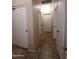 Clean hallway with tile flooring and multiple doors at 812 W Saint Anne Ave, Phoenix, AZ 85041