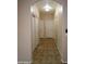 Clean hallway with tile flooring and access to bedrooms and closets at 812 W Saint Anne Ave, Phoenix, AZ 85041