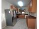 Modern kitchen offering stainless steel appliances and wood cabinets at 812 W Saint Anne Ave, Phoenix, AZ 85041