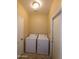 Laundry room with washer, dryer, and extra storage at 812 W Saint Anne Ave, Phoenix, AZ 85041