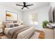 Modern bedroom with a cozy bed, neutral decor, and a bright window for natural light at 12271 N 74Th St, Scottsdale, AZ 85260