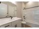 Modern bathroom with white vanity, bathtub, and shower at 18955 W Ocotillo Rd, Waddell, AZ 85355