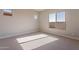 Bright bedroom with carpet flooring and large windows at 18955 W Ocotillo Rd, Waddell, AZ 85355