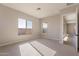 Spacious bedroom with carpet flooring, large windows and access to another room at 18955 W Ocotillo Rd, Waddell, AZ 85355