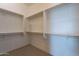 Spacious walk-in closet with ample shelving and hanging rods at 18955 W Ocotillo Rd, Waddell, AZ 85355