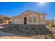 Modern one-story house with stone accents and a desert landscape at 18955 W Ocotillo Rd, Waddell, AZ 85355