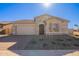 One-story home with stone accents, landscaped yard, and two-car garage at 18955 W Ocotillo Rd, Waddell, AZ 85355