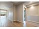 Bright hallway with wood-look tile flooring and recessed lighting at 18955 W Ocotillo Rd, Waddell, AZ 85355