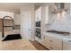 White cabinets, granite countertops, and a black farmhouse sink in the kitchen at 18955 W Ocotillo Rd, Waddell, AZ 85355