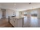 Open concept kitchen with island, stainless steel appliances, and tile flooring at 18955 W Ocotillo Rd, Waddell, AZ 85355