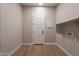 Convenient laundry room with storage shelves and door at 18955 W Ocotillo Rd, Waddell, AZ 85355