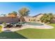 Inviting backyard oasis featuring a sparkling pool, lush landscaping, and patio seating at 20722 N 38Th St, Phoenix, AZ 85050