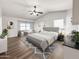 Spacious main bedroom with a king-size bed, built in shelving, and plenty of natural light at 20722 N 38Th St, Phoenix, AZ 85050