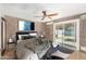 Cozy bedroom featuring brick walls, contemporary decor, and a sliding glass door leading to the backyard at 3033 E Sierra St, Phoenix, AZ 85028