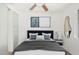 Bright bedroom featuring white walls, modern decor, and a ceiling fan for added comfort at 3033 E Sierra St, Phoenix, AZ 85028