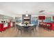 Bright kitchen and dining area with modern red cabinetry, stainless appliances, and pool views at 3033 E Sierra St, Phoenix, AZ 85028