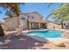Serene backyard featuring a refreshing pool, covered patio, built-in grill, and mature trees for added privacy at 1663 S Boulder St, Gilbert, AZ 85295