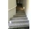 Carpeted staircase with white handrail and recessed lighting, providing a safe and stylish transition between floors at 19537 N 69Th Ave, Glendale, AZ 85308