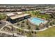 An aerial view of a pristine pool and community center surrounded by lush landscaping and stylish homes at 21715 N 61St Way, Phoenix, AZ 85054