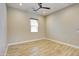 Neutral bedroom showcases wood-look floors, ceiling fan, and window for natural light at 21715 N 61St Way, Phoenix, AZ 85054