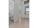 Bright entryway featuring neutral tile floors, a half-bath, and a glimpse into the adjacent living space at 4405 N 203Rd Ave, Buckeye, AZ 85396