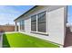 Exterior view showing artificial turf, and a modern style stucco home at 4405 N 203Rd Ave, Buckeye, AZ 85396